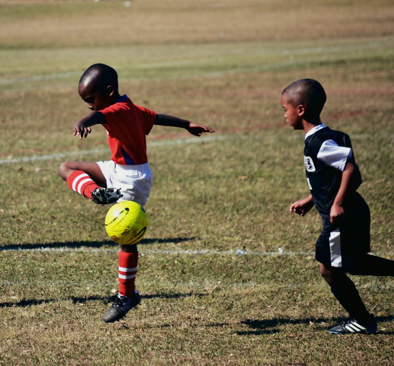 Young player controlling the ball mid-match