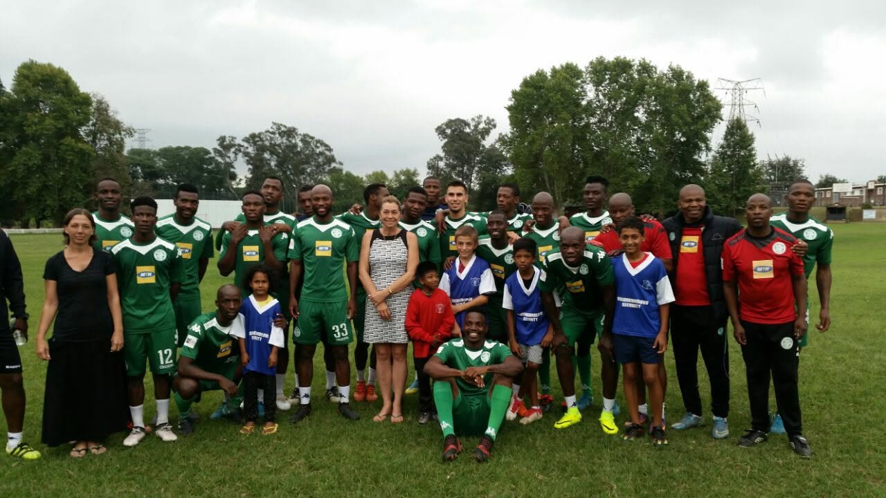 Junior team celebrating with medals and trophy